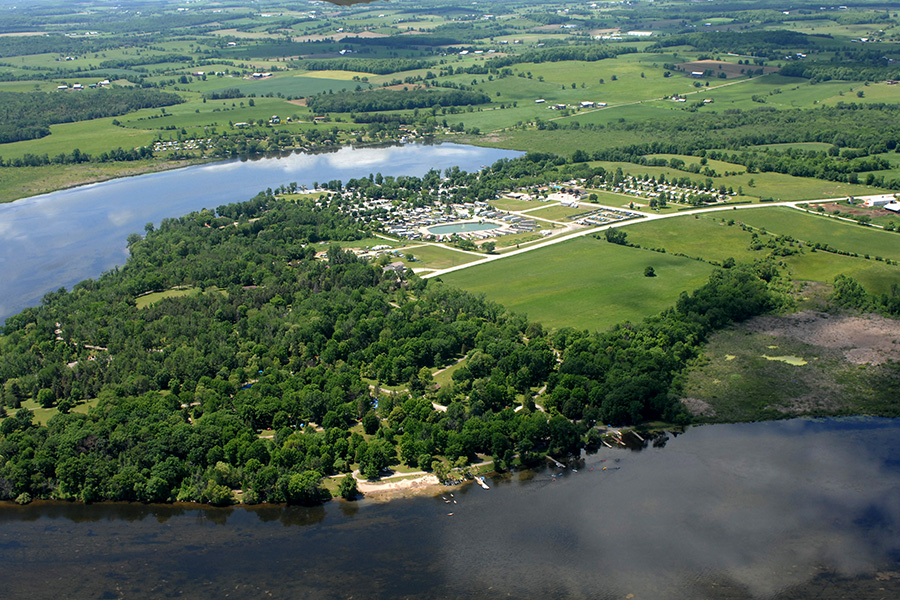 a veiw of a lake surrounded by forest and feild